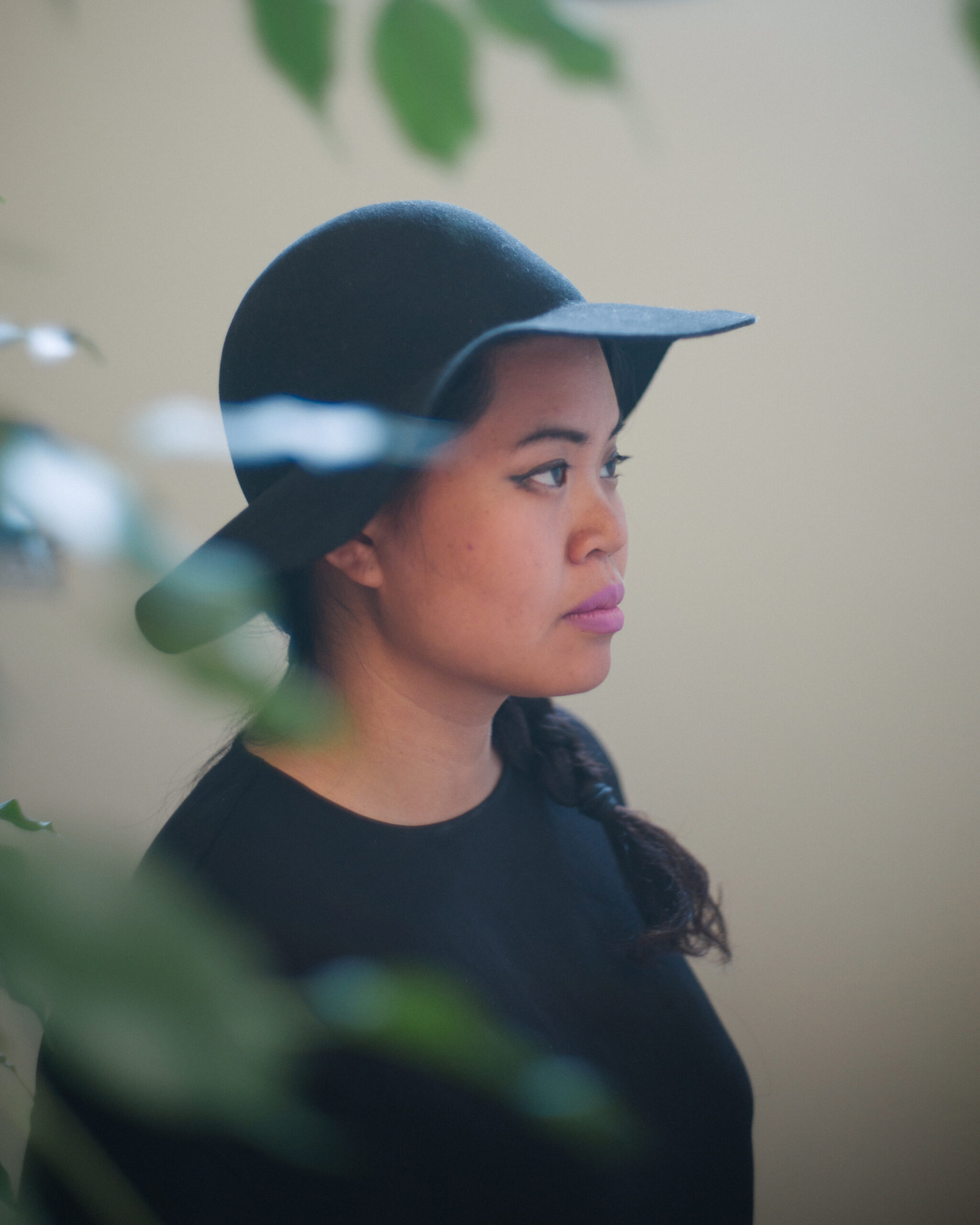 Patricia Nguyen wearing a hat surrounded by greenery